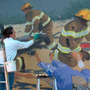 Cheryl Mann painting a mural.